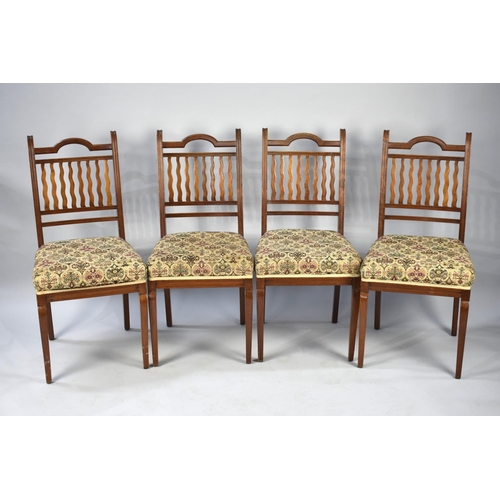 554 - A Set of Four Edwardian Mahogany Framed Dining Chairs with tapestry Upholstery