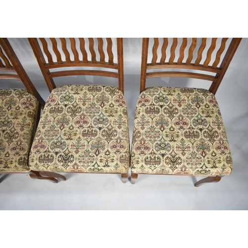 554 - A Set of Four Edwardian Mahogany Framed Dining Chairs with tapestry Upholstery