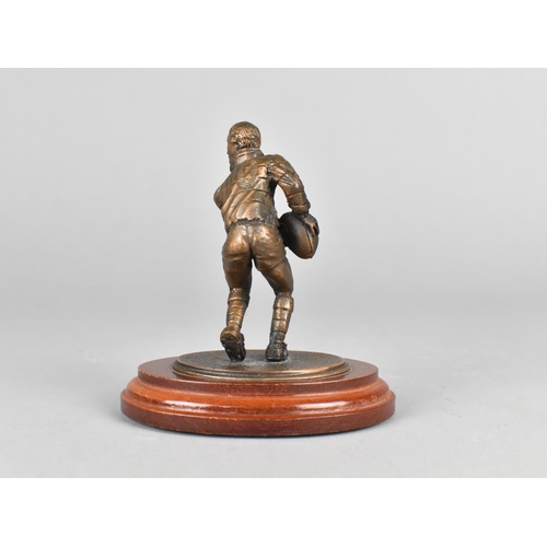 10 - A Modern Bronze Effect Figure of Rugby Player on Oval Wooden Plinth, 10cms High