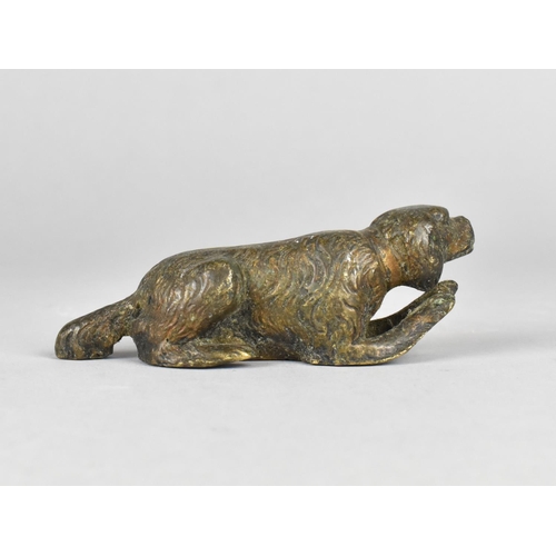 11 - A Patinated Bronze Study of a Reclining Spaniel, 9cms Long