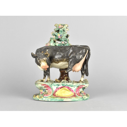 A Mid 19th Century Staffordshire Pearlware Study of Dairy Cow Being Bitten on Hind Leg by Snake, Flowering Bocage Behind, Some Losses to Leg, Horn and Bocage, in The Manner of Obadiah Sherratt, 22cms High