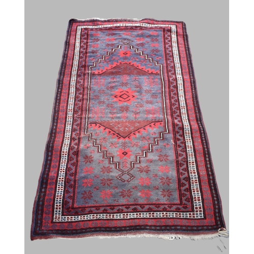 481 - A Vintage Patterned Afghan Patterned Rug on Red Ground, 185x105cm