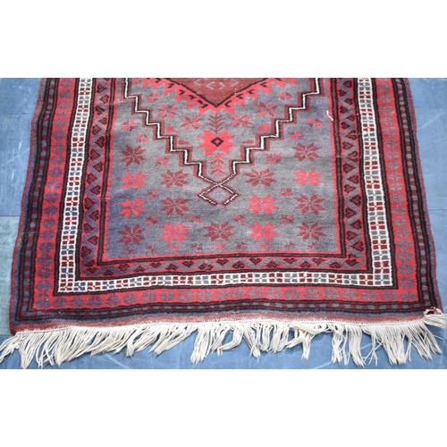 481 - A Vintage Patterned Afghan Patterned Rug on Red Ground, 185x105cm