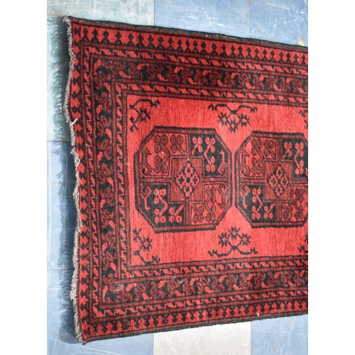 489 - A Vintage Persian Pattern Rug on Red Ground, 145x100cm