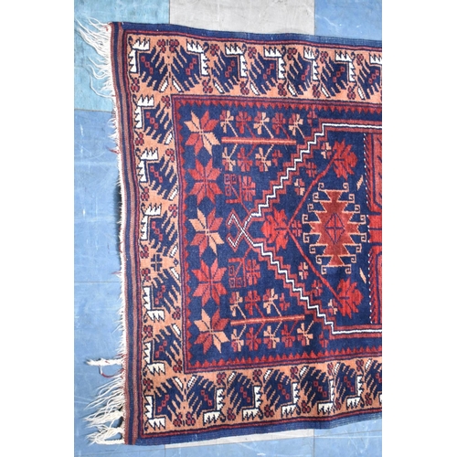 493 - A Patterned Rug on Blue Ground, 137x78cm