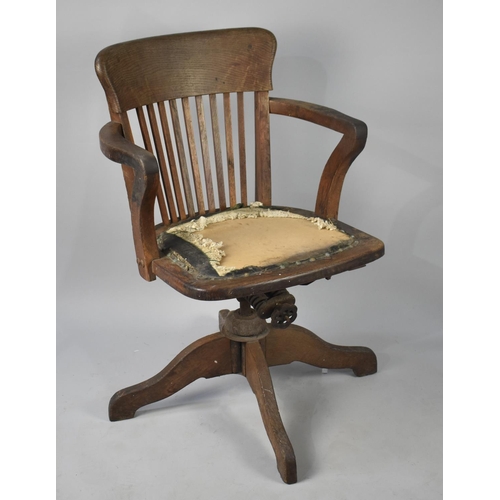 495 - An Edwardian Oak Framed Swivel Office Chair with Lath Back and Scrolled Armrests, The Metal Adjustab... 