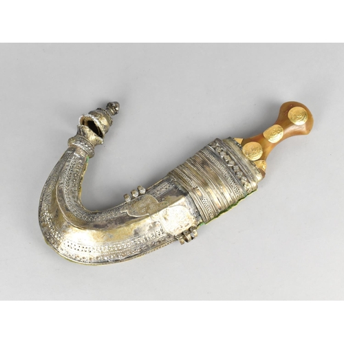 65 - A Omani Curved Blade Dagger or Jambiya with Gilt Mounted Horn Handle and White Metal Scabbard, Condi... 