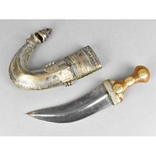 65 - A Omani Curved Blade Dagger or Jambiya with Gilt Mounted Horn Handle and White Metal Scabbard, Condi... 