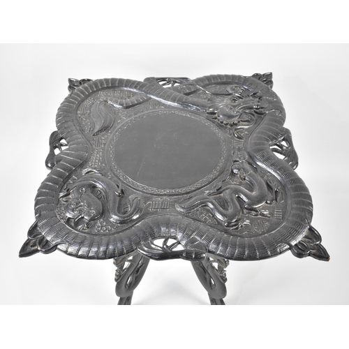 70 - A Carved Ebonized Chinese Table Decorated in High Relief with Dragons, 67cms Square, Folding Carved ... 