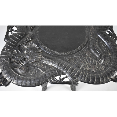 70 - A Carved Ebonized Chinese Table Decorated in High Relief with Dragons, 67cms Square, Folding Carved ... 