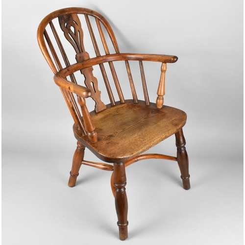 448 - A 19th Century Child's Windsor Armchair, The Back with Pierced Splat and Turned Rails Above Conformi... 