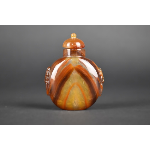 379 - A Chinese Hardstone Snuff Bottle with Carved Lion Ring Mask Faux Handles, 7.5cm High