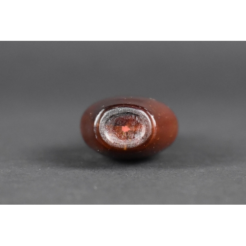 376 - A Chinese Gold Flecked Hardstone Snuff Bottle with Amethyst Stopper, 9cm High