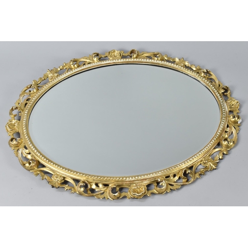 182 - An Early 20th Century Giltwood and Gesso Oval Framed Mirror with Bevel Glass, The Frame with Pierced... 