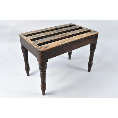 76 - An Edwardian Mahogany Luggage Stand with Slatted Top Above Turned Supports, 60x38x43cm High