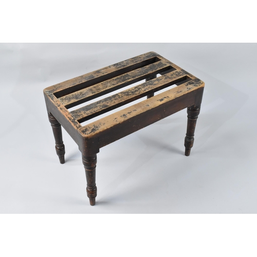 76 - An Edwardian Mahogany Luggage Stand with Slatted Top Above Turned Supports, 60x38x43cm High