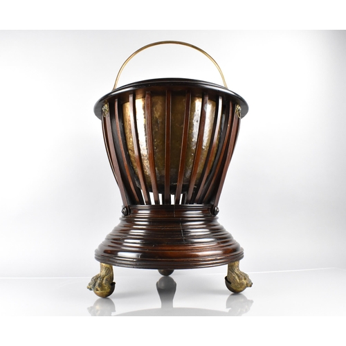 73 - A Mahogany Regency Jardiniere of Urn From with Slatted Body Having Lion Ring Masks and Raised on Thr... 