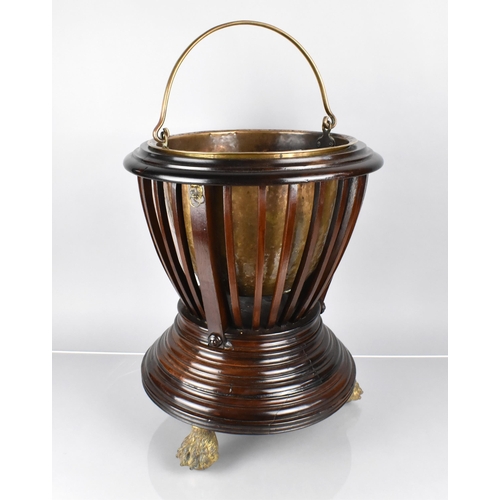 73 - A Mahogany Regency Jardiniere of Urn From with Slatted Body Having Lion Ring Masks and Raised on Thr... 