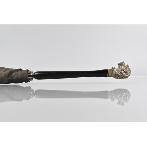 64 - An Early 20th Century Ladies Parasol with Ebonised Handle and White Metal Finial Modelled as a Dogs ... 