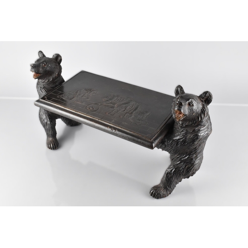 66 - A Late 19th Century Black Forest Table Top Stand Modelled with Carved Bears Supporting Carved Top, D... 