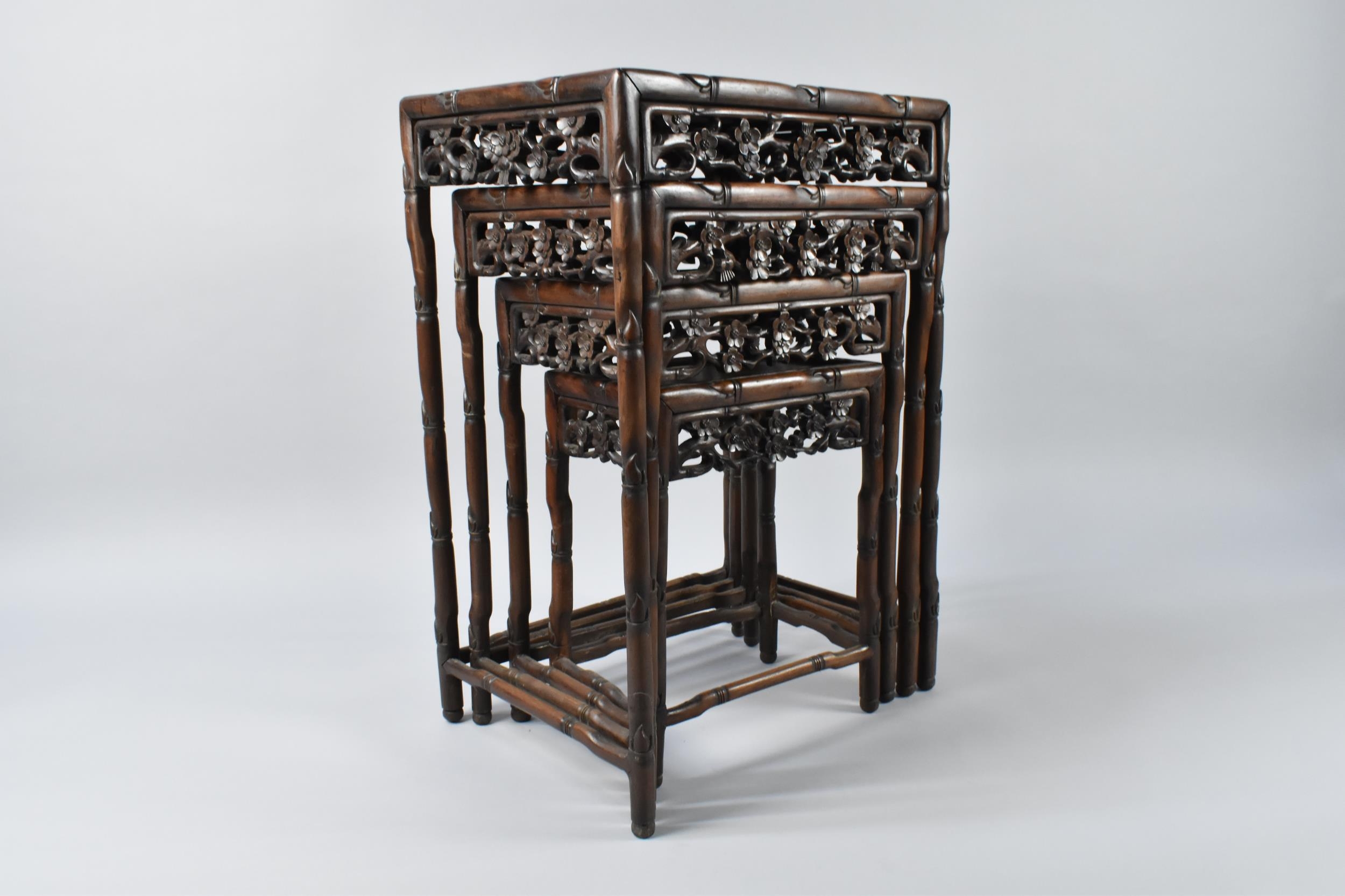 A Chinese Hardwood Nest of Four Tables Having Floral Carved Aprons and ...