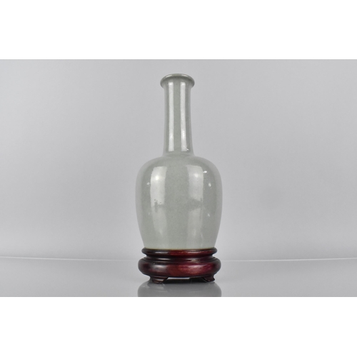 381 - A Chinese Celadon Glazed Bottle Vase, The Base with 37 Character Inscription for Qianlong, 19cm High... 