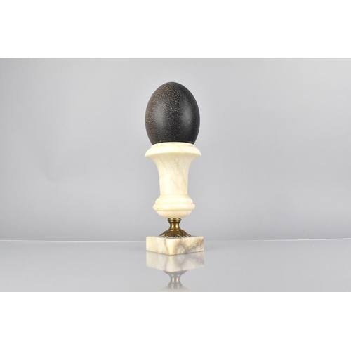 50 - An Emu Egg Mounted on An Alabaster and Ormolu Classical Urn, 29cm High