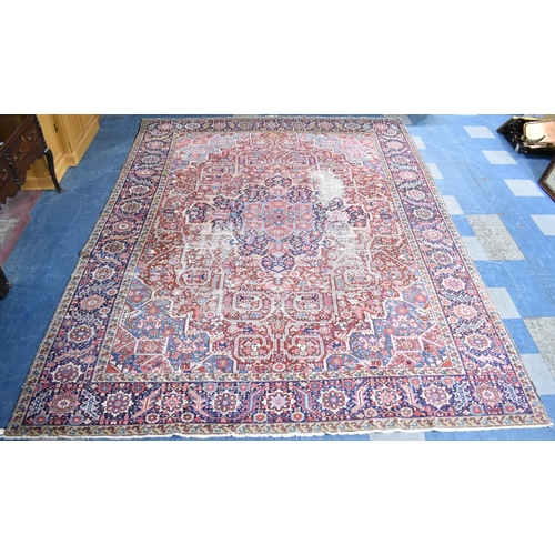 200 - WITHDRAWN: An Early 20th Century Handmade Persian Heriz Pattern Carpet on Red Ground, C.1910, 390x29... 