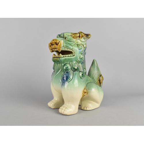 235 - A Chinese Glazed Ceramic Study of a Seated Temple Dog, 22cms High