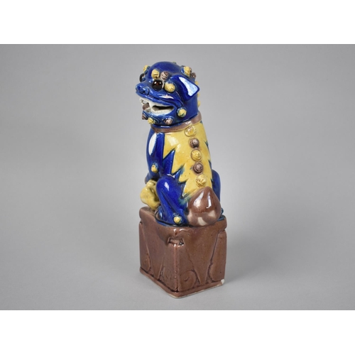 239 - A Glazed Chinese Porcelain Study of Seated Temple Lion, 21.5cms High