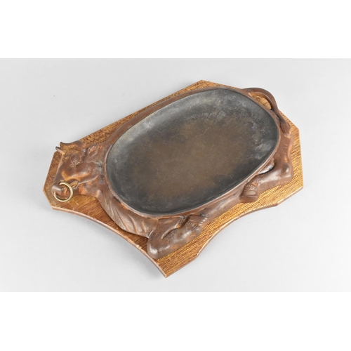 261 - A Cast Metal Sizzling Plate in the Form of a Reclining Bull on Wooden Base, 34cms Long