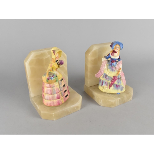 36 - A Pair of Mid 20th Century Onyx Bookends with Crinoline Lady Ceramic Figures, 14cms High