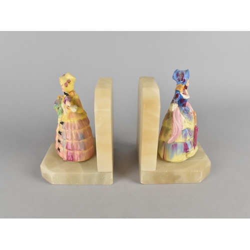 36 - A Pair of Mid 20th Century Onyx Bookends with Crinoline Lady Ceramic Figures, 14cms High