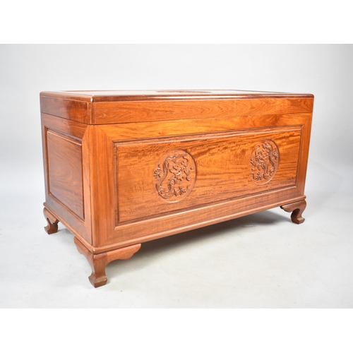 551 - An Oriental Camphor Wood Chest with Hinged Lid Having Carved Dragon Details, 101cms Wide