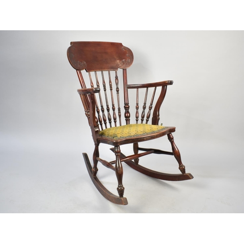 559 - A Vintage Spindle Backed Rocking Chair with Upholstered Pad Feet