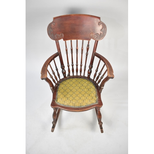 559 - A Vintage Spindle Backed Rocking Chair with Upholstered Pad Feet