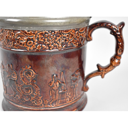 66 - A 19th Century Treacle Glazed Pewter Lidded Tankard, Body Decorated in Relief with The Winged Lion o... 