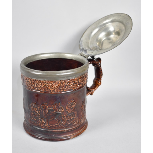 66 - A 19th Century Treacle Glazed Pewter Lidded Tankard, Body Decorated in Relief with The Winged Lion o... 