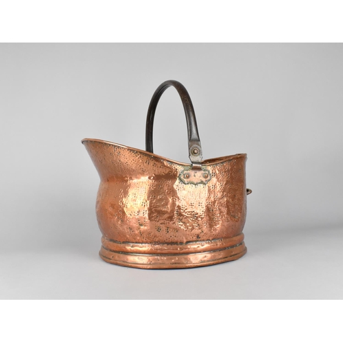 87 - A Mid 20th Century Copper Helmet Shaped Coal Scuttle, 35.5cms Long