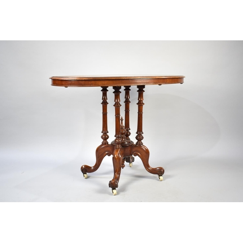 103 - A Victorian Oval Topped Occasional Table with Extended Birdcage Supports and Scrolled Seat Culminati... 