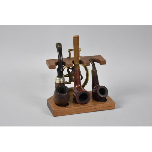 119 - A Vintage Pipe Rack with Horse Brass Mount and Containing Three Vintage Pipes