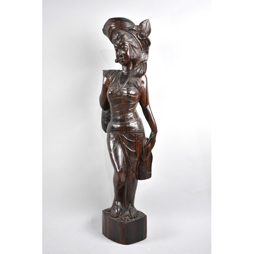 24 - An Indonesian Carved Hardwood Study of a Maiden, 61cms High