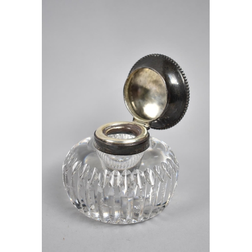 38 - A Circular Glass Desktop Inkwell with Sterling Silver Hinged Lid and Collar, 8.5cms High