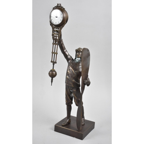 44 - A Reproduction Bronze Novelty Mystery Clock in the Form of an Early Pilot Holding Propellor, 38cms H... 