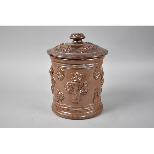 61 - A Treacle Glazed Stoneware Tobacco Pot with Relief Floral Decoration to Body, Chip to Base Rim, 17.5... 