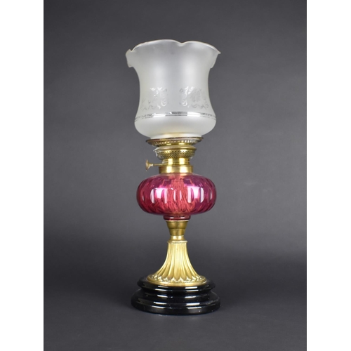 86 - A Victorian Brass and Cranberry Glass Oil Lamp with Etched Shade, 49cms High Overall