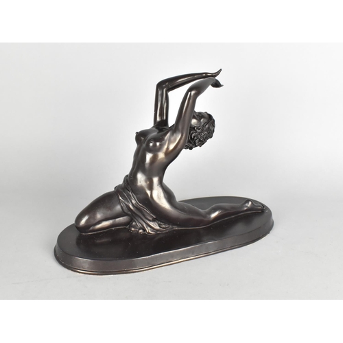 90 - A Modern Resin Bronze Effect Figure of a Dancing Nude, Oval Base, 30cms Long