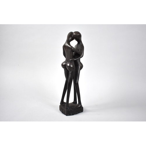 92 - An Ebonised Carved Wooden Modern Art Sculpture, Lovers Kissing, 31cms High