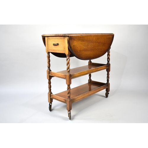 98 - A Mid 20th Century Oak Three Tier Drop Leaf Trolley with Barley Twist Support and End Drawer, 74cms ... 