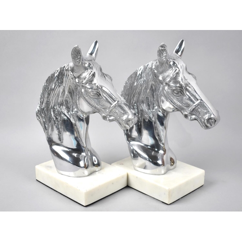 107 - A Pair of Silver Plated Bookends in the Form of Horses Heads with Faux White Marble Base, 24cms High